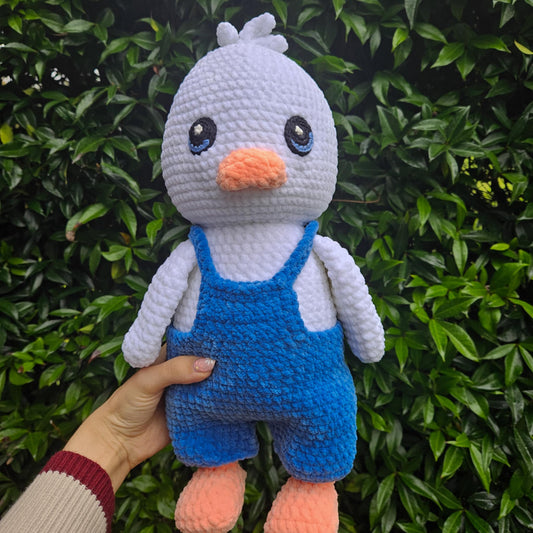 Cute duck wearing blue overalls